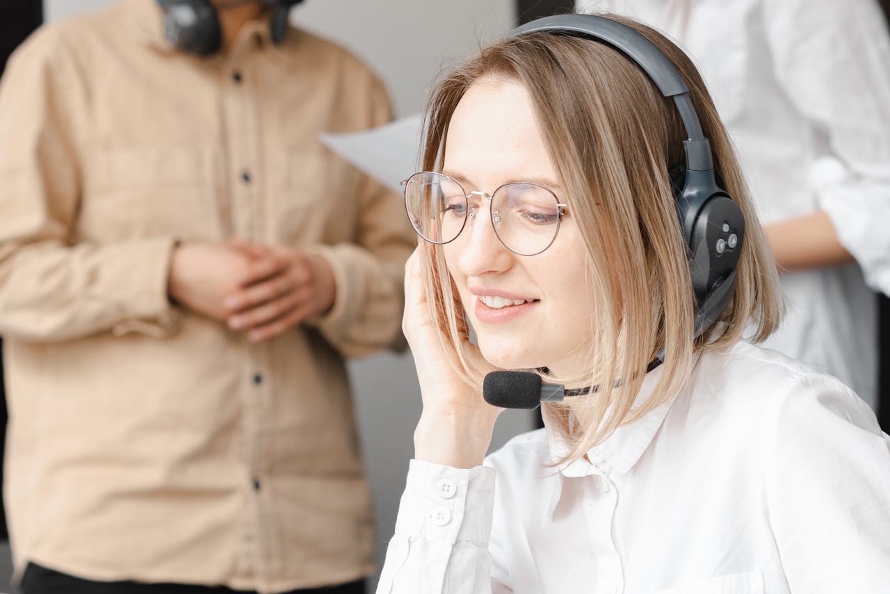 about-us Professional woman providing customer support with a headset in an office setting.